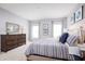 Serene bedroom featuring a comfortable bed with blue accents, soft lighting, and stylish decor at 744 Cantaberry Dr, Dundee, FL 33838
