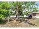 Expansive backyard with shade trees, storage sheds and a glimpse of the home's screened in porch at 910 Nw 56Th Ave, Ocala, FL 34482