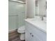 This bathroom features tile floors, a glass shower, white vanity, and ample lighting at 910 Nw 56Th Ave, Ocala, FL 34482