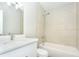 This bathroom features tile floors, a shower-tub combo, white vanity, and ample lighting at 910 Nw 56Th Ave, Ocala, FL 34482
