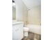This bathroom features tile floors, a shower-tub combo, white vanity, and ample lighting at 910 Nw 56Th Ave, Ocala, FL 34482