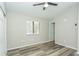 This bedroom features neutral paint, wood-look floors, a window with blinds, and closet with sliding doors at 910 Nw 56Th Ave, Ocala, FL 34482