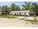 Charming single-story home featuring a metal roof and ample parking space at 910 Nw 56Th Ave, Ocala, FL 34482