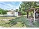 Home's exterior features a storage shed and covered structure in a large tree-shaded yard at 910 Nw 56Th Ave, Ocala, FL 34482