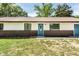 Inviting single-story home featuring a metal roof and lush front lawn at 910 Nw 56Th Ave, Ocala, FL 34482