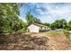 Side view of a humble home with minimal landscaping, showcasing its simple and functional design at 910 Nw 56Th Ave, Ocala, FL 34482