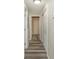 Inviting hallway with modern gray wood-look flooring and access to multiple rooms at 910 Nw 56Th Ave, Ocala, FL 34482