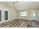 Bright living room with modern flooring, fresh paint, and ample natural light at 910 Nw 56Th Ave, Ocala, FL 34482