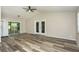 Open living area with new floors, vaulted ceilings, and doors to patio at 910 Nw 56Th Ave, Ocala, FL 34482