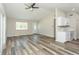 Open-concept living room with new floors, vaulted ceiling, and kitchen view at 910 Nw 56Th Ave, Ocala, FL 34482