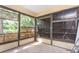 This sun room features a concrete floor, floor to ceiling windows, and a ladder at 910 Nw 56Th Ave, Ocala, FL 34482