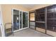 This sunroom has sliding doors with access to inside of the house, next to windows and a folding ladder at 910 Nw 56Th Ave, Ocala, FL 34482