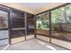 Enclosed sunroom featuring multiple windows and a concrete floor, perfect for enjoying the outdoors from the comfort of home at 910 Nw 56Th Ave, Ocala, FL 34482
