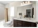 Bright bathroom features a double vanity, large mirror, modern fixtures, and a tiled shower and bathtub combination at 9836 Pine Mill Ct, Clermont, FL 34711