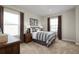 Comfortable bedroom featuring two windows, decorative lamps, and stylish gray bedding at 9836 Pine Mill Ct, Clermont, FL 34711