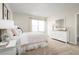 Bright bedroom features a large window, a dresser with mirror, side tables with lamps, and stylish pink bedding at 9836 Pine Mill Ct, Clermont, FL 34711