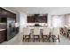 Modern kitchen with stainless steel appliances, dark wood cabinets, and white quartz countertops at 9836 Pine Mill Ct, Clermont, FL 34711