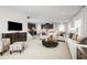 Open-concept living room with neutral walls, recessed lights, plush sofas, and views to the kitchen at 9836 Pine Mill Ct, Clermont, FL 34711
