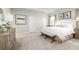 Bright main bedroom with a tray ceiling, neutral walls, a king bed, and modern decor at 9836 Pine Mill Ct, Clermont, FL 34711