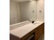 Bright bathroom featuring a large mirror and a vanity with a white countertop at 2600 Ocean Shore Blvd # 111, Ormond Beach, FL 32176