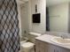 Neutral bathroom with a shower/tub, toilet, and vanity with a beige countertop at 2600 Ocean Shore Blvd # 111, Ormond Beach, FL 32176