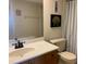 Bathroom featuring tile floors, wood cabinets, and a combination shower and tub at 2600 Ocean Shore Blvd # 111, Ormond Beach, FL 32176