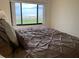 Bedroom featuring a queen bed and ocean view at 2600 Ocean Shore Blvd # 111, Ormond Beach, FL 32176