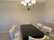 Dining room with a modern chandelier and furniture covered for protection at 2600 Ocean Shore Blvd # 111, Ormond Beach, FL 32176