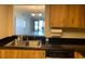 Kitchen featuring a stainless steel sink with views of a bright living area and ocean at 2600 Ocean Shore Blvd # 111, Ormond Beach, FL 32176
