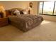 Bedroom featuring a queen bed, dresser, and bedside tables with lamps at 2600 Ocean Shore Blvd # 111, Ormond Beach, FL 32176