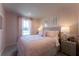 Charming bedroom with soft pink walls, plush carpet, and natural light at 680 Four Leaf Ave, Debary, FL 32713