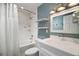 Bathroom featuring a shower over tub with marble-look tile and floating shelves at 7355 Se 106Th Pl, Belleview, FL 34420