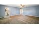 This primary bedroom features carpet floors, a ceiling fan, and an ensuite bathroom at 7355 Se 106Th Pl, Belleview, FL 34420