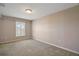 Bedroom featuring neutral carpet, ceiling fan and window with plantation shutters at 7355 Se 106Th Pl, Belleview, FL 34420