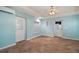 Bonus room with beautiful floor tiles, ceiling fan, and three access doors at 7355 Se 106Th Pl, Belleview, FL 34420