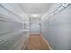 This walk-in closet features carpet floors, shelving, and clothing rods at 7355 Se 106Th Pl, Belleview, FL 34420