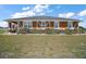 Charming single-story home featuring a unique facade, well-manicured bushes, and a lovely green lawn at 7355 Se 106Th Pl, Belleview, FL 34420