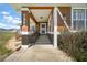 A welcoming, covered front porch with decorative columns and a well-kept entrance at 7355 Se 106Th Pl, Belleview, FL 34420
