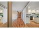 Bright hallway with hardwood floors, barn doors, and a view into the kitchen and living area at 7355 Se 106Th Pl, Belleview, FL 34420