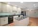 A well-lit kitchen featuring marble countertops, sleek appliances and a view to the living area at 7355 Se 106Th Pl, Belleview, FL 34420