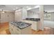 This spacious kitchen island has granite counters, wood floors, and white cabinets at 7355 Se 106Th Pl, Belleview, FL 34420
