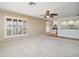 A spacious living room with neutral color palette and an open view to the kitchen at 7355 Se 106Th Pl, Belleview, FL 34420