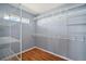 Walk-in closet featuring custom wire shelving and hardwood floors for ample storage at 7355 Se 106Th Pl, Belleview, FL 34420