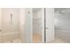 Bathroom featuring tiled shower with a bench, a walk-in closet, and a doorway at 9262 Sw 102Nd Avenue Rd, Ocala, FL 34481