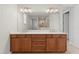 Modern bathroom features double vanity, white countertops, and large mirror reflecting a shower with glass door at 9262 Sw 102Nd Avenue Rd, Ocala, FL 34481