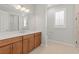 Modern bathroom with dual sinks, a large mirror, and a glass-enclosed shower at 9262 Sw 102Nd Avenue Rd, Ocala, FL 34481