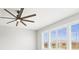 Bright room with a ceiling fan, large window with plantation shutters, and modern ceiling fan at 9262 Sw 102Nd Avenue Rd, Ocala, FL 34481