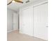 Neutral bedroom showcasing closet doors, neutral walls, and tiled floor at 9262 Sw 102Nd Avenue Rd, Ocala, FL 34481