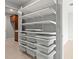 Well-organized closet with white shelving and storage baskets, complemented by wood cabinetry at 9262 Sw 102Nd Avenue Rd, Ocala, FL 34481