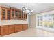 Open dining area featuring built in cabinetry, modern lighting, and plantation shutters at 9262 Sw 102Nd Avenue Rd, Ocala, FL 34481